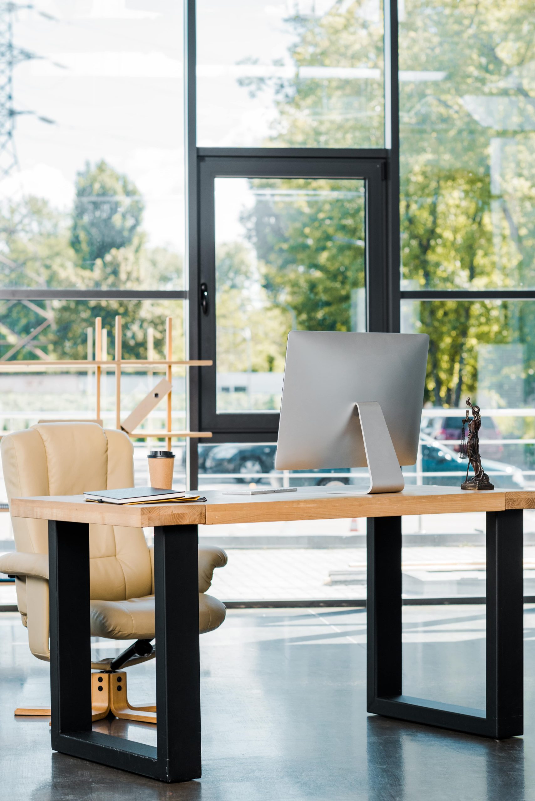 Modern office desk and furniture in a glass walled office