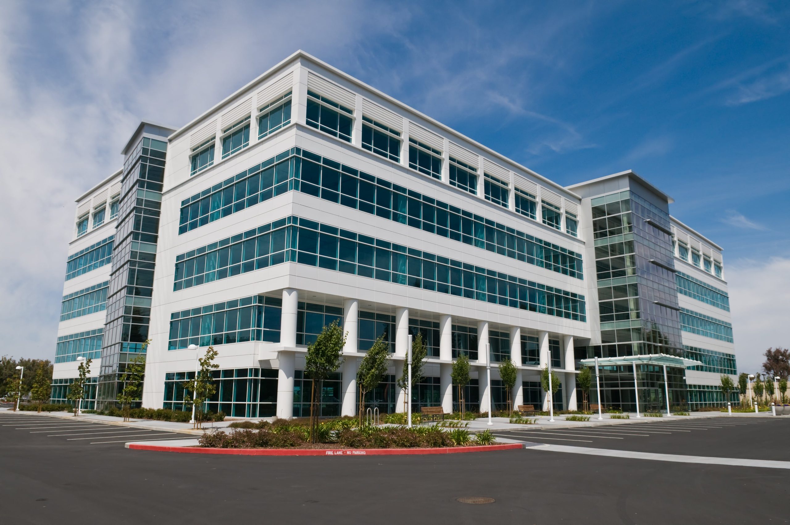 Modern white commercial building with glass windows