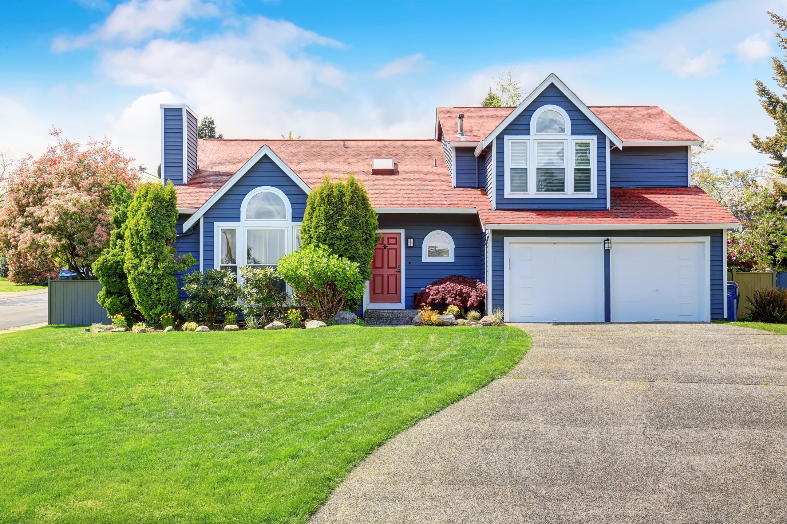 Large blue house with white trim and nice yard